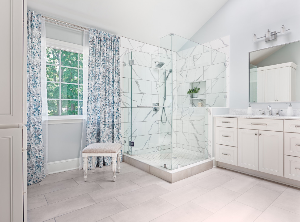 Inspiration for a large transitional master bathroom in Charlotte with recessed-panel cabinets, white cabinets, a corner shower, blue tile, porcelain tile, blue walls, porcelain floors, an undermount sink, engineered quartz benchtops, grey floor, white benchtops, a niche, a double vanity and a built-in vanity.