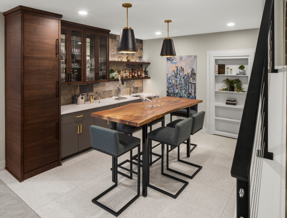 Design ideas for a mid-sized contemporary galley seated home bar in Minneapolis with flat-panel cabinets, dark wood cabinets, wood benchtops, multi-coloured splashback, cement tile splashback, ceramic floors, white floor and white benchtop.