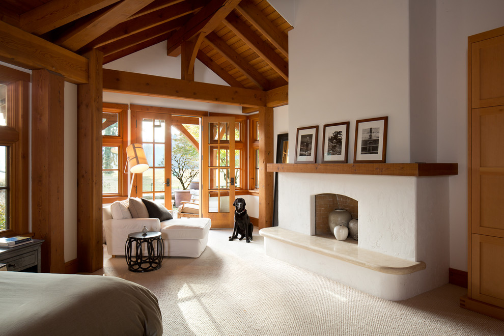Inspiration for a country bedroom in Vancouver with white walls, carpet and a standard fireplace.