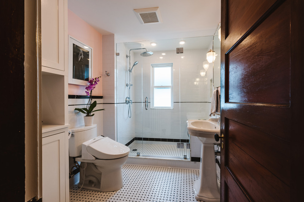 Photo of a small traditional master bathroom in Boston with an open shower, a bidet, black and white tile, subway tile, pink walls, porcelain floors, a pedestal sink, a hinged shower door, a shower seat, a single vanity and decorative wall panelling.