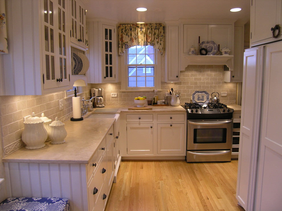 Design ideas for a traditional kitchen in DC Metro with limestone benchtops and panelled appliances.