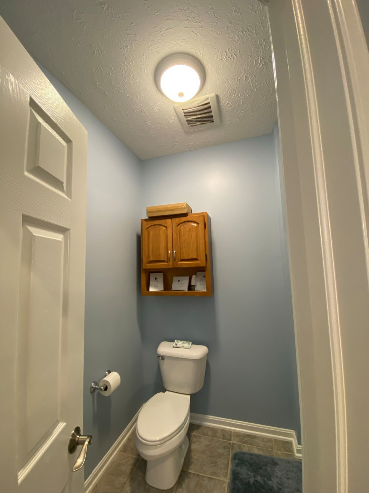 This is an example of a modern cloakroom in Cleveland with a one-piece toilet and white walls.