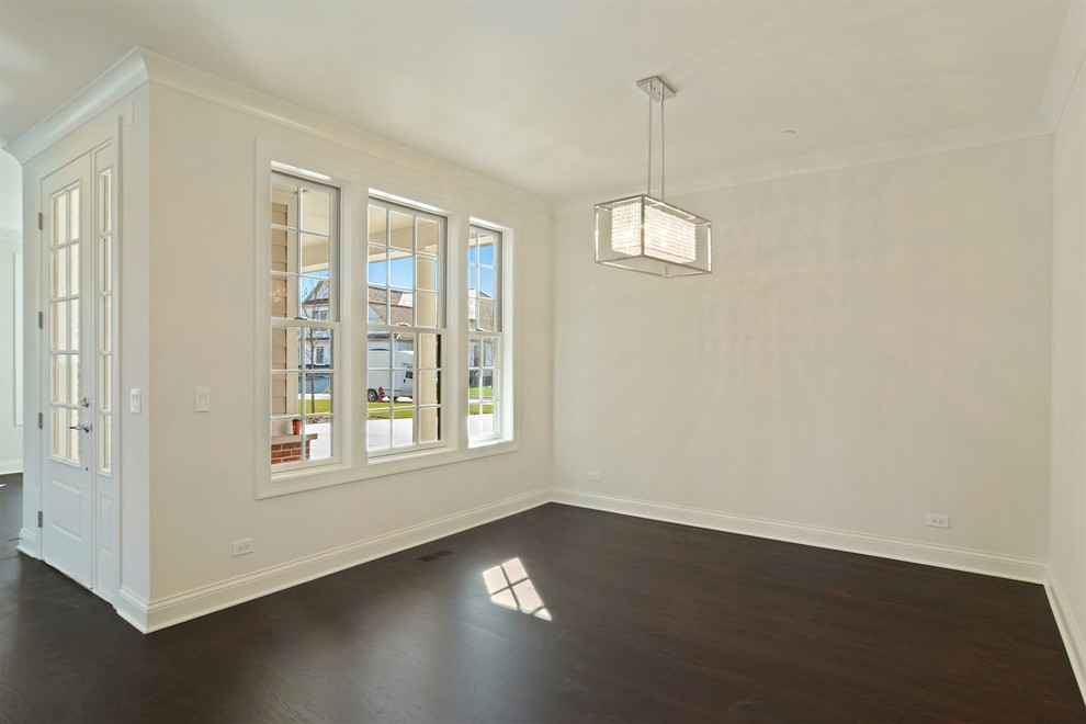 Photo of a mid-sized contemporary dining room in Chicago with white walls and dark hardwood floors.