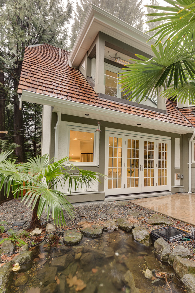Example of a transitional home design design in Vancouver