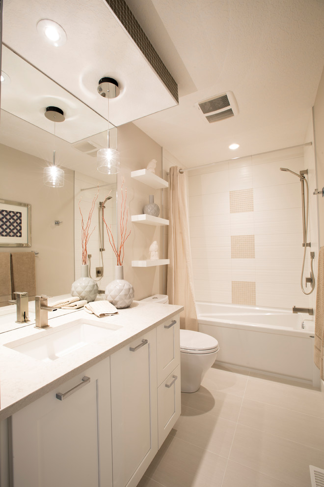 Mid-sized transitional kids' white tile and ceramic tile ceramic tile alcove bathtub photo in Calgary with shaker cabinets, white cabinets, a two-piece toilet, an undermount sink and quartzite countertops