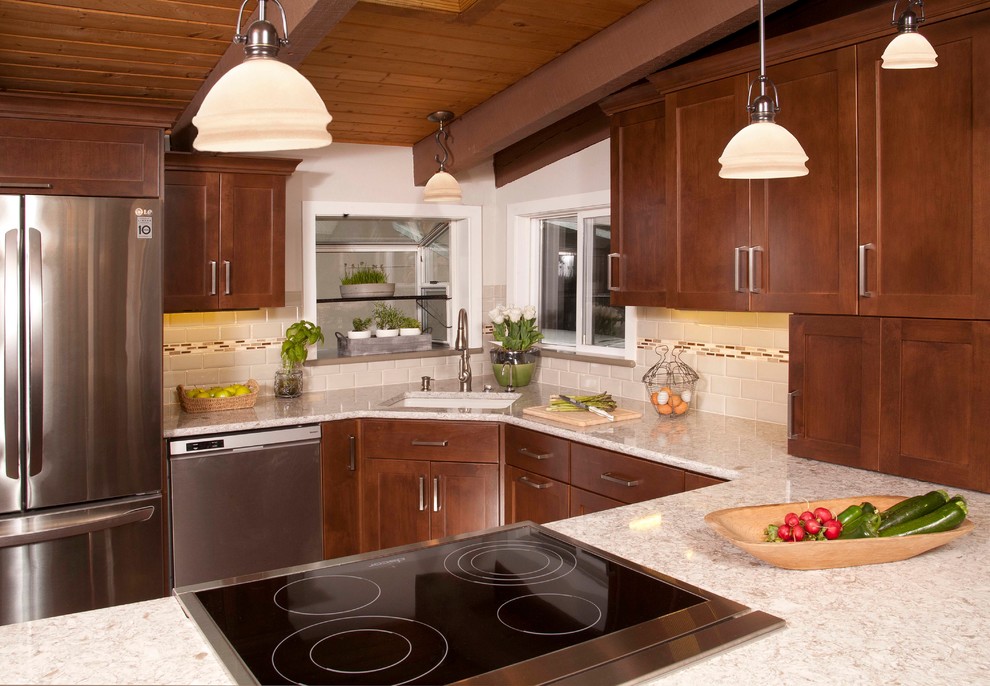 Inspiration for a mid-sized transitional dark wood floor kitchen remodel in Seattle with an undermount sink, shaker cabinets, dark wood cabinets, beige backsplash, subway tile backsplash, stainless steel appliances and a peninsula
