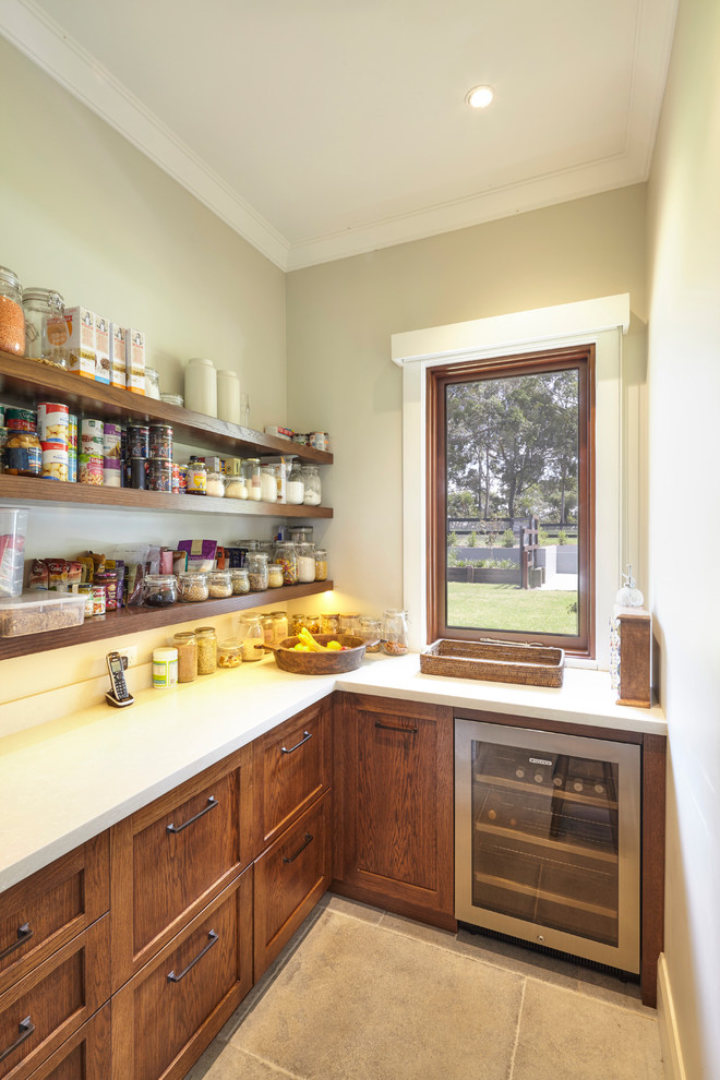 Photo of a small country l-shaped kitchen pantry in Sydney with shaker cabinets, medium wood cabinets, quartz benchtops, beige splashback, stone slab splashback, stainless steel appliances and ceramic floors.