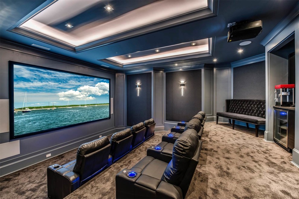 Photo of a transitional enclosed home theatre in New York with grey walls, carpet, a projector screen and brown floor.