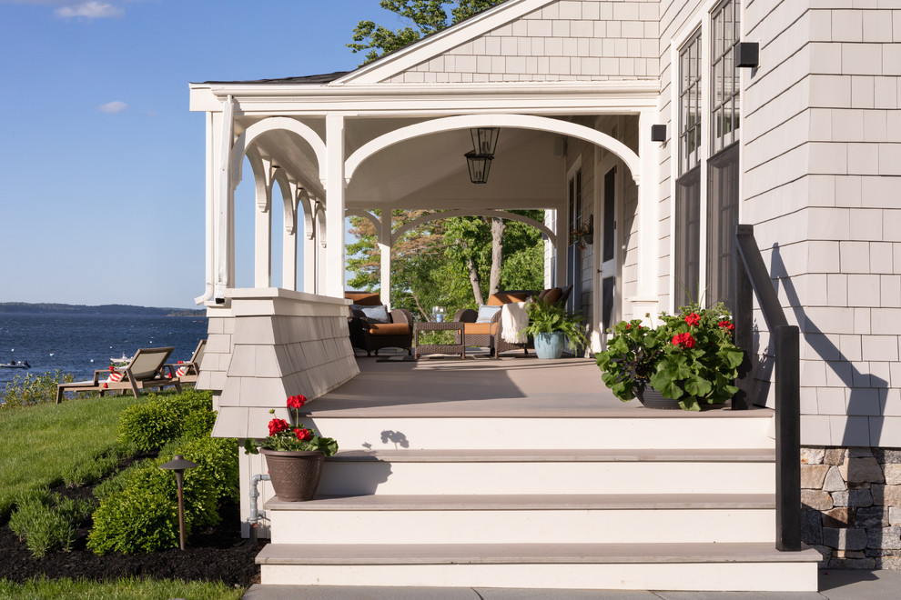 Beach style verandah in Boston with a roof extension.