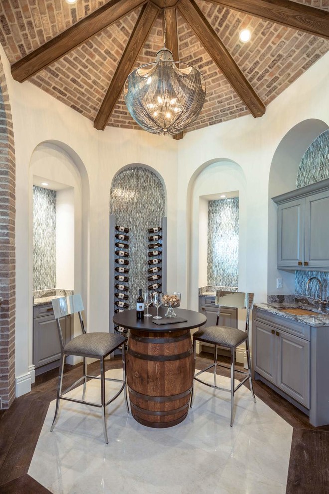 Design ideas for a large mediterranean wine cellar in Miami with marble floors, display racks and white floor.
