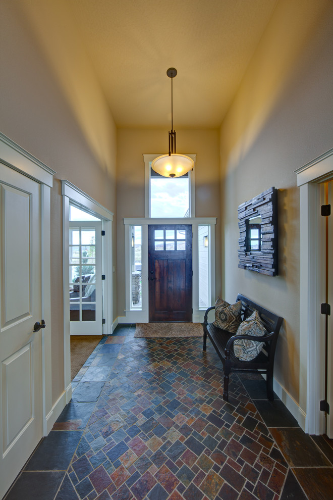 Example of a mid-sized transitional ceramic tile and multicolored floor foyer design in Seattle with beige walls and a dark wood front door
