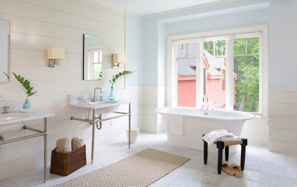 This is an example of a traditional bathroom in Portland Maine with a console sink and a freestanding tub.