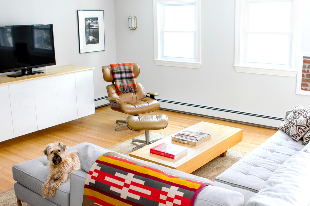 Photo of an eclectic family room in Portland Maine with grey walls.