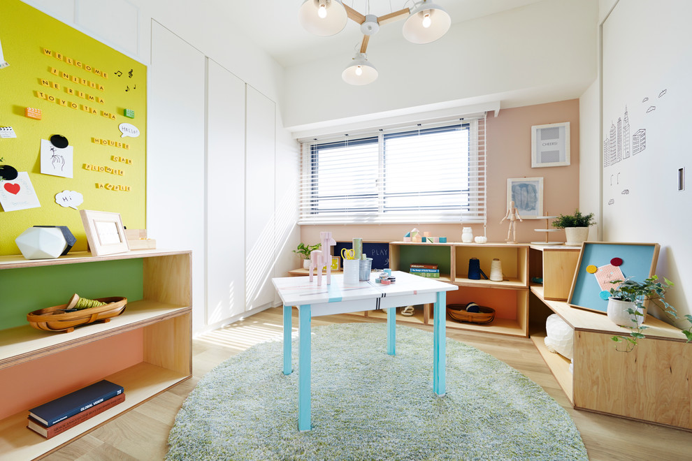 Photo of a small scandinavian gender-neutral kids' playroom for kids 4-10 years old in Tokyo with white walls and light hardwood floors.