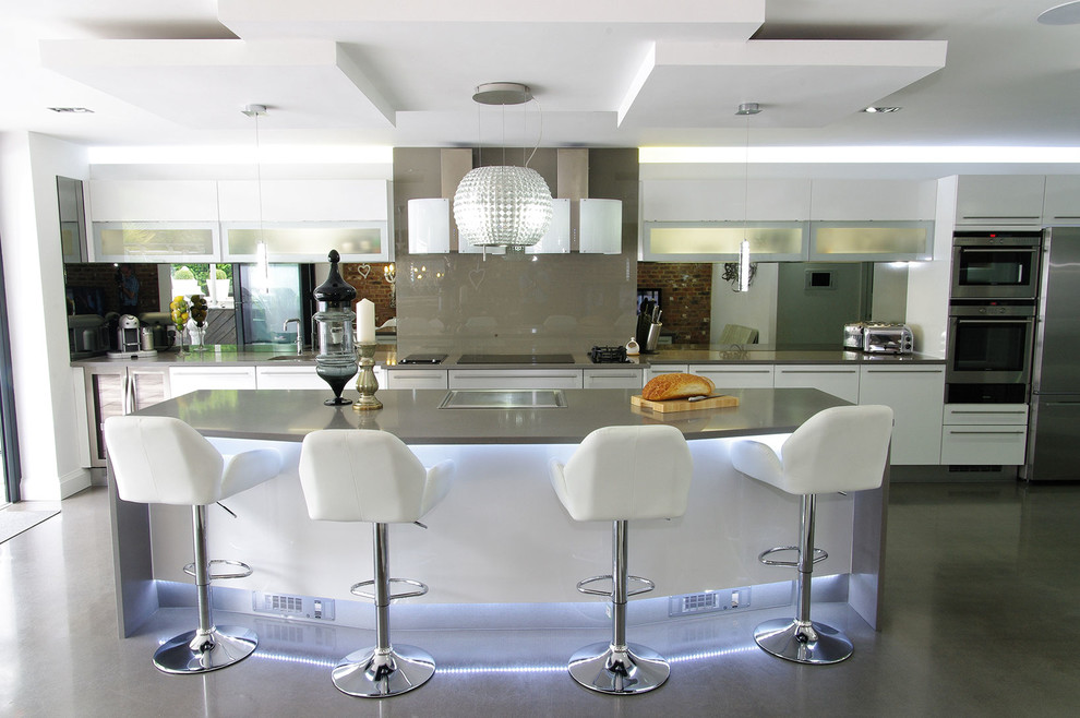 Inspiration for a contemporary kitchen in Kent with flat-panel cabinets, white cabinets and with island.