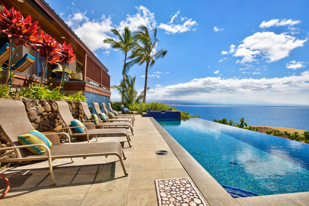 Inspiration for a tropical backyard rectangular infinity pool in Hawaii.