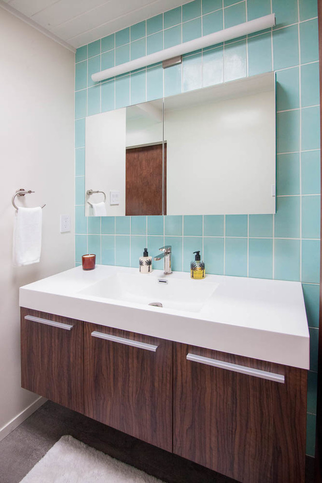 Photo of a small midcentury bathroom in San Francisco with flat-panel cabinets, dark wood cabinets, an alcove tub, blue tile and ceramic tile.