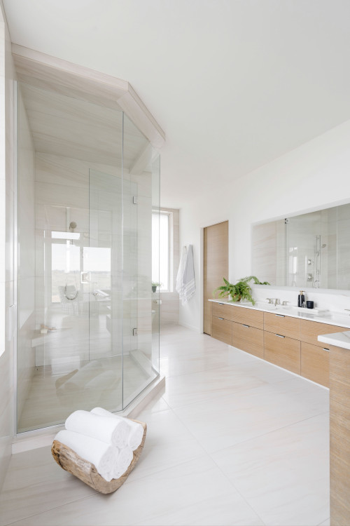 Contemporary Comfort: Light Wood Flat-Panel Cabinets in a Spacious Bathroom with White Tops