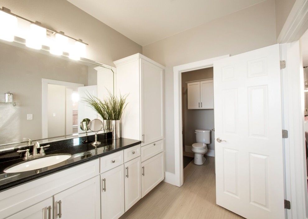 Example of a transitional kids' beige tile and porcelain tile porcelain tile home design design in Austin with shaker cabinets, white cabinets, beige walls, an undermount sink and granite countertops