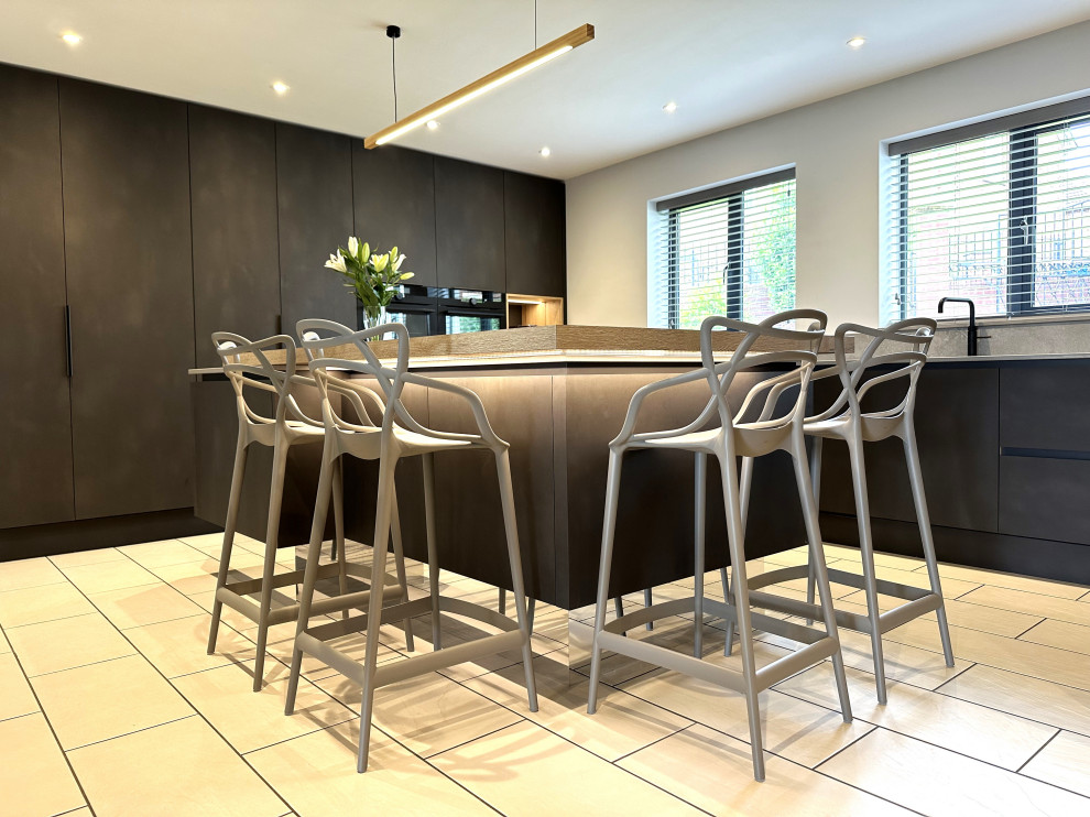 Medium sized contemporary l-shaped kitchen/diner in Other with an integrated sink, flat-panel cabinets, black appliances, porcelain flooring, an island and feature lighting.