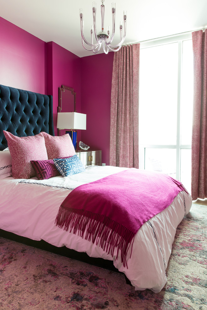 Eclectic bedroom in New Orleans with pink walls, carpet and multi-coloured floor.