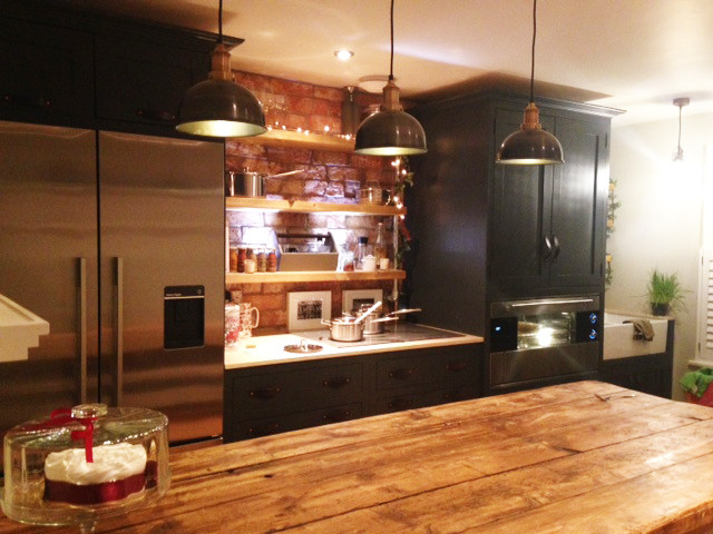 Photo of a small traditional galley eat-in kitchen in London with a farmhouse sink, shaker cabinets, grey cabinets, quartzite benchtops, stainless steel appliances and with island.