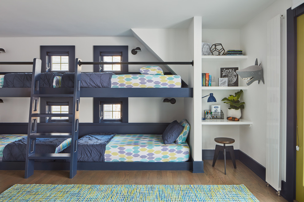 Design ideas for a beach style kids' bedroom for kids 4-10 years old and boys in Manchester with white walls and medium hardwood floors.