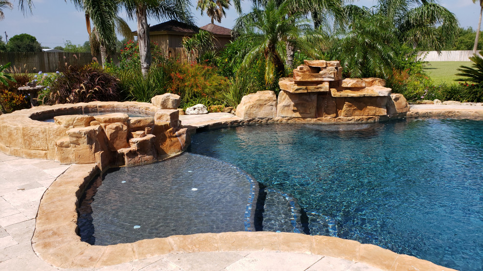 Inspiration for a large country backyard custom-shaped natural pool in Austin with natural stone pavers.