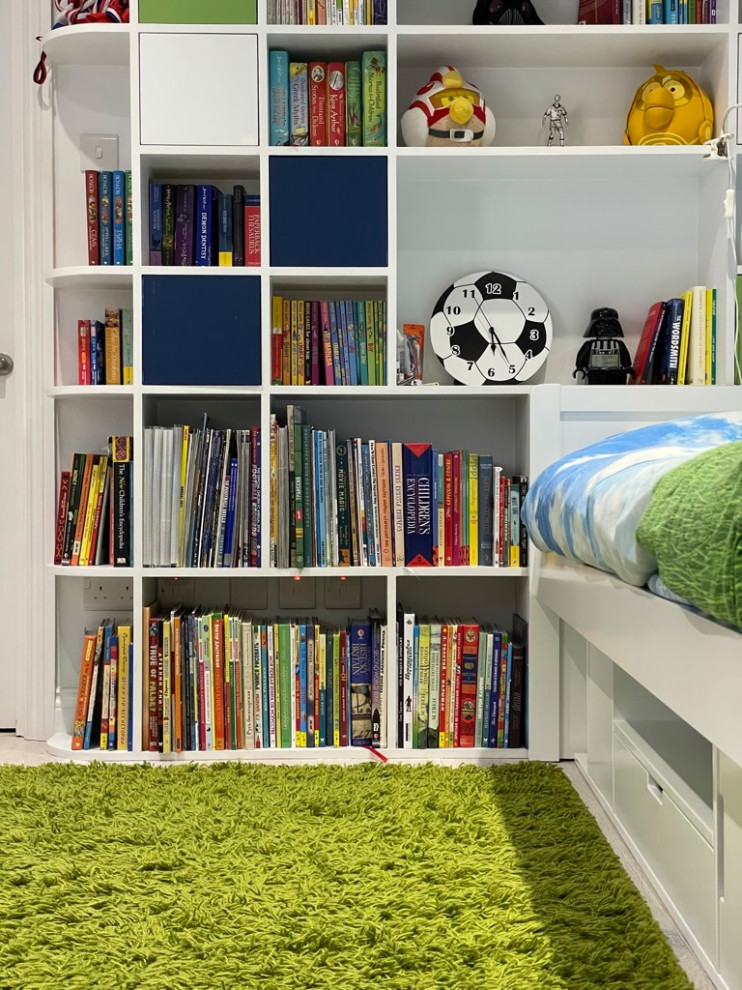 Inspiration for a medium sized contemporary children’s room for boys in London with blue walls, light hardwood flooring and beige floors.