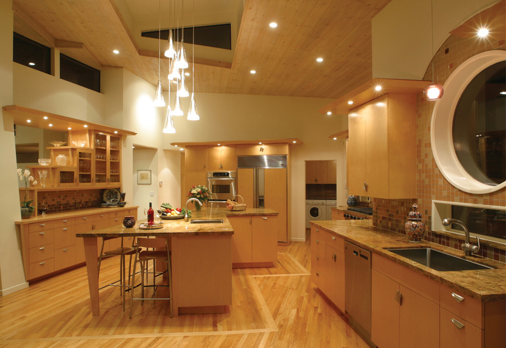 This is an example of a contemporary kitchen in Los Angeles with a single-bowl sink, flat-panel cabinets and light wood cabinets.