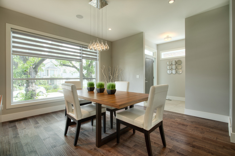 Contemporary dining room in Calgary with grey walls.