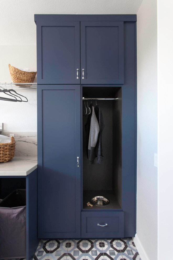 This is an example of a mid-sized modern galley dedicated laundry room in San Diego with flat-panel cabinets, blue cabinets, white walls, ceramic floors and multi-coloured floor.