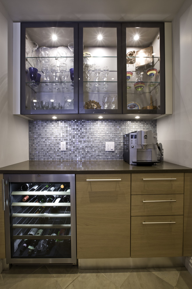 Photo of a contemporary home bar in New York with glass-front cabinets, medium wood cabinets and blue splashback.