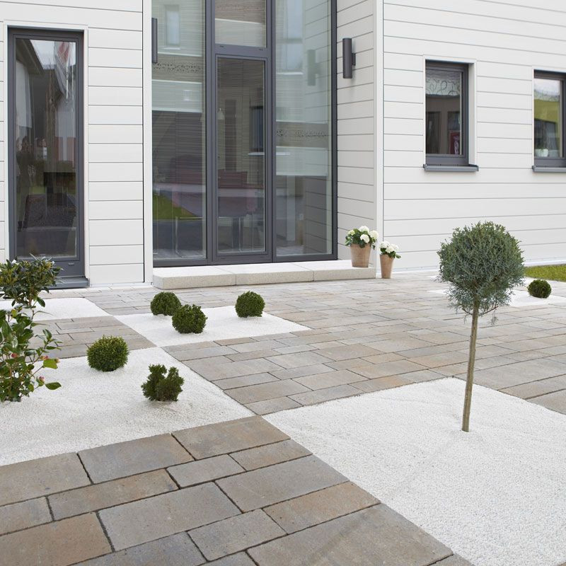 This is an example of a mid-sized scandinavian side yard partial sun garden for spring in Other with with rock feature and gravel.