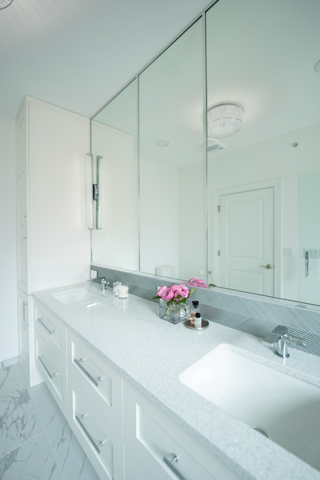 This is an example of a medium sized modern ensuite bathroom in Chicago with recessed-panel cabinets, white cabinets, an alcove shower, white walls, porcelain flooring, a submerged sink, engineered stone worktops, white floors, a hinged door, grey worktops, a shower bench, double sinks and a built in vanity unit.