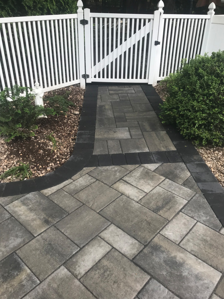 Mid-sized transitional concrete paver pool photo