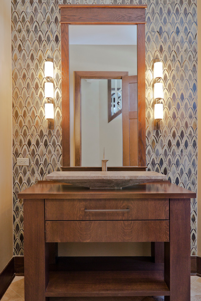 This is an example of a mid-sized contemporary powder room in Tampa with furniture-like cabinets, medium wood cabinets, multi-coloured tile, mosaic tile, a trough sink, wood benchtops and brown benchtops.