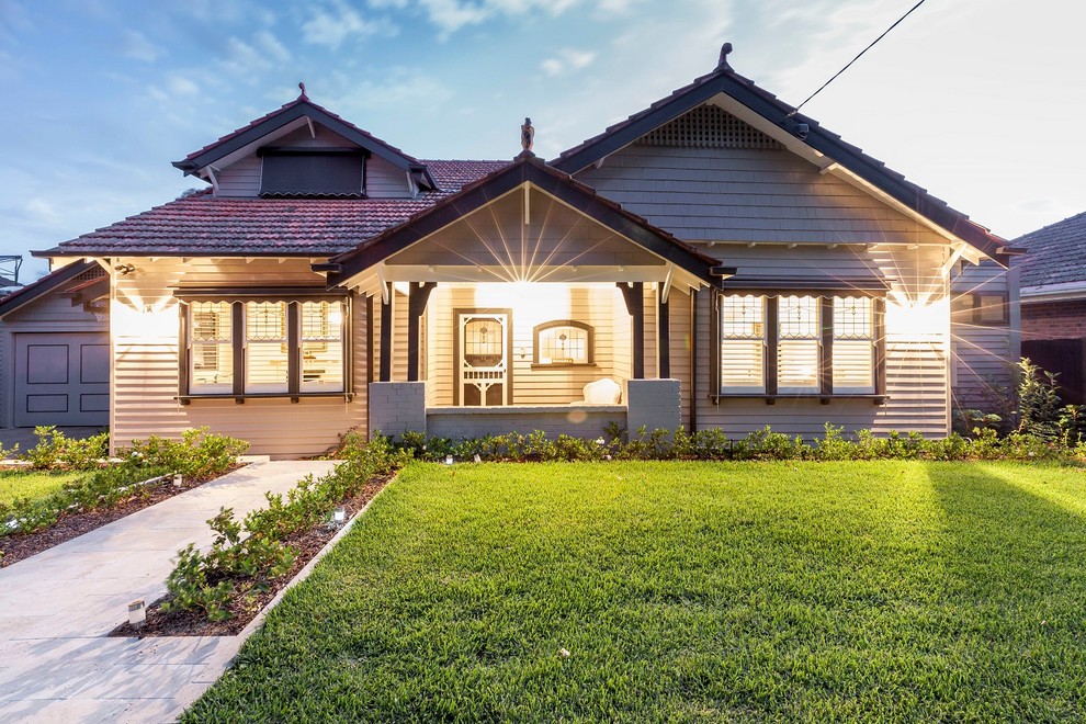 This is an example of a large transitional two-storey grey exterior in Melbourne with wood siding and a gable roof.