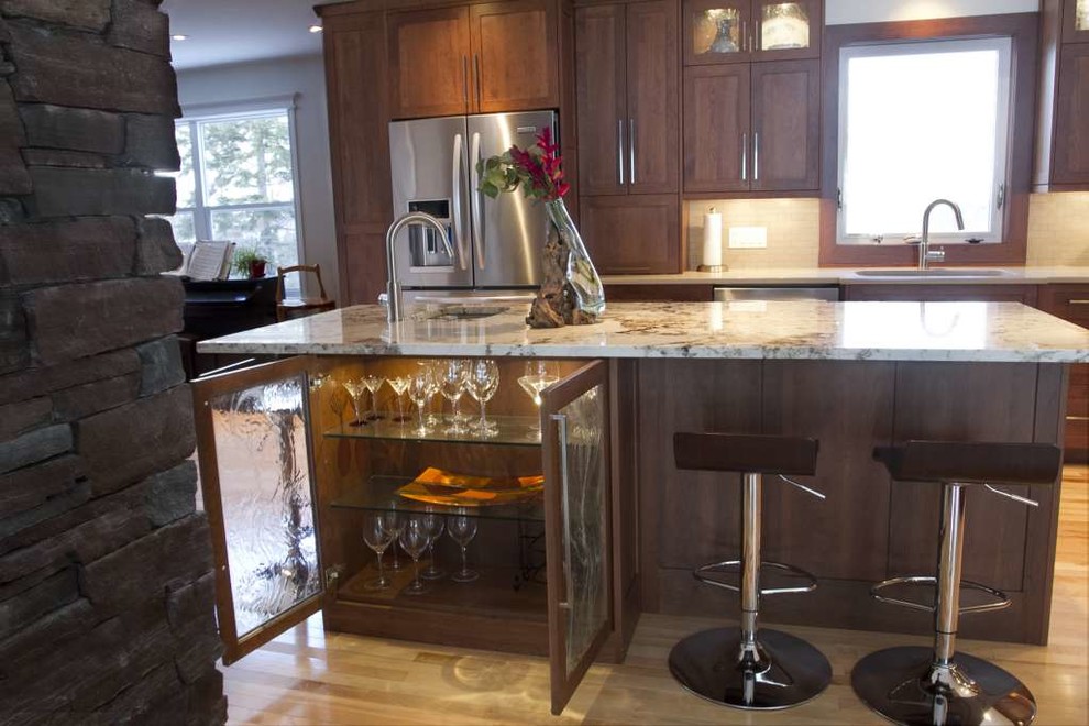Open concept kitchen - mid-sized transitional l-shaped light wood floor and beige floor open concept kitchen idea with an undermount sink, shaker cabinets, dark wood cabinets, quartz countertops, beige backsplash, porcelain backsplash, stainless steel appliances and an island