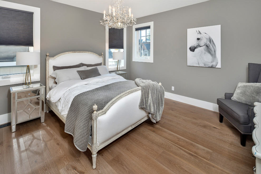 Example of a transitional medium tone wood floor and brown floor bedroom design