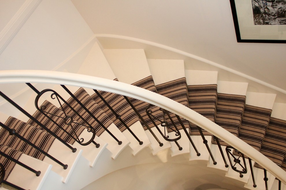 Photo of a large traditional wood curved staircase in Sydney with wood risers and wood railing.