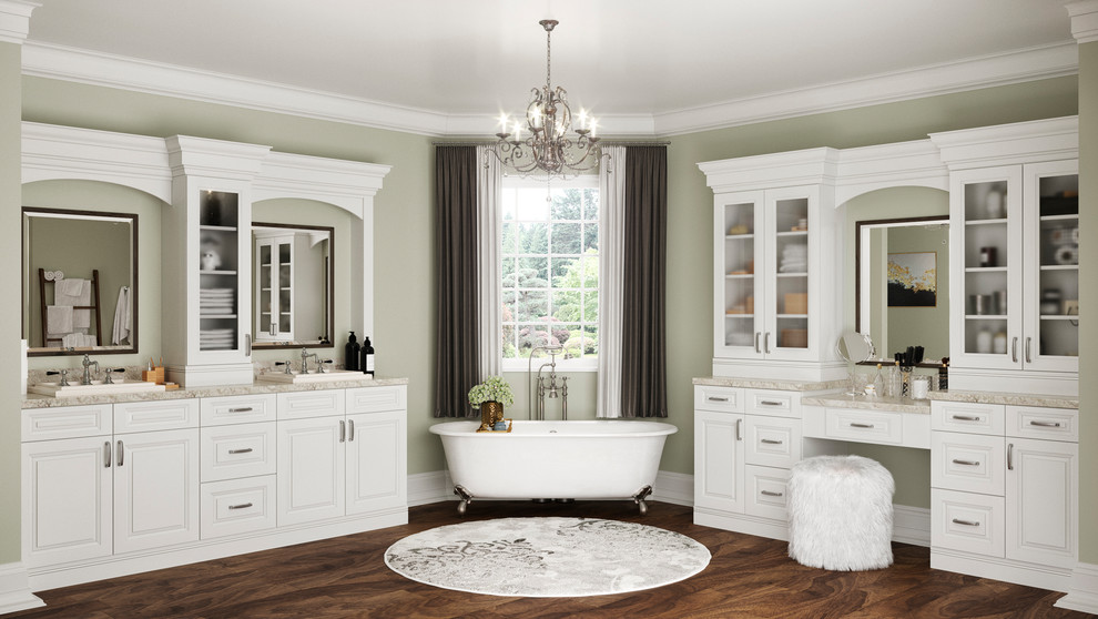 Design ideas for an expansive modern master bathroom with raised-panel cabinets, white cabinets, a claw-foot tub, a double shower, a one-piece toilet, white tile, beige walls, laminate floors, an integrated sink, granite benchtops, brown floor, a hinged shower door and beige benchtops.