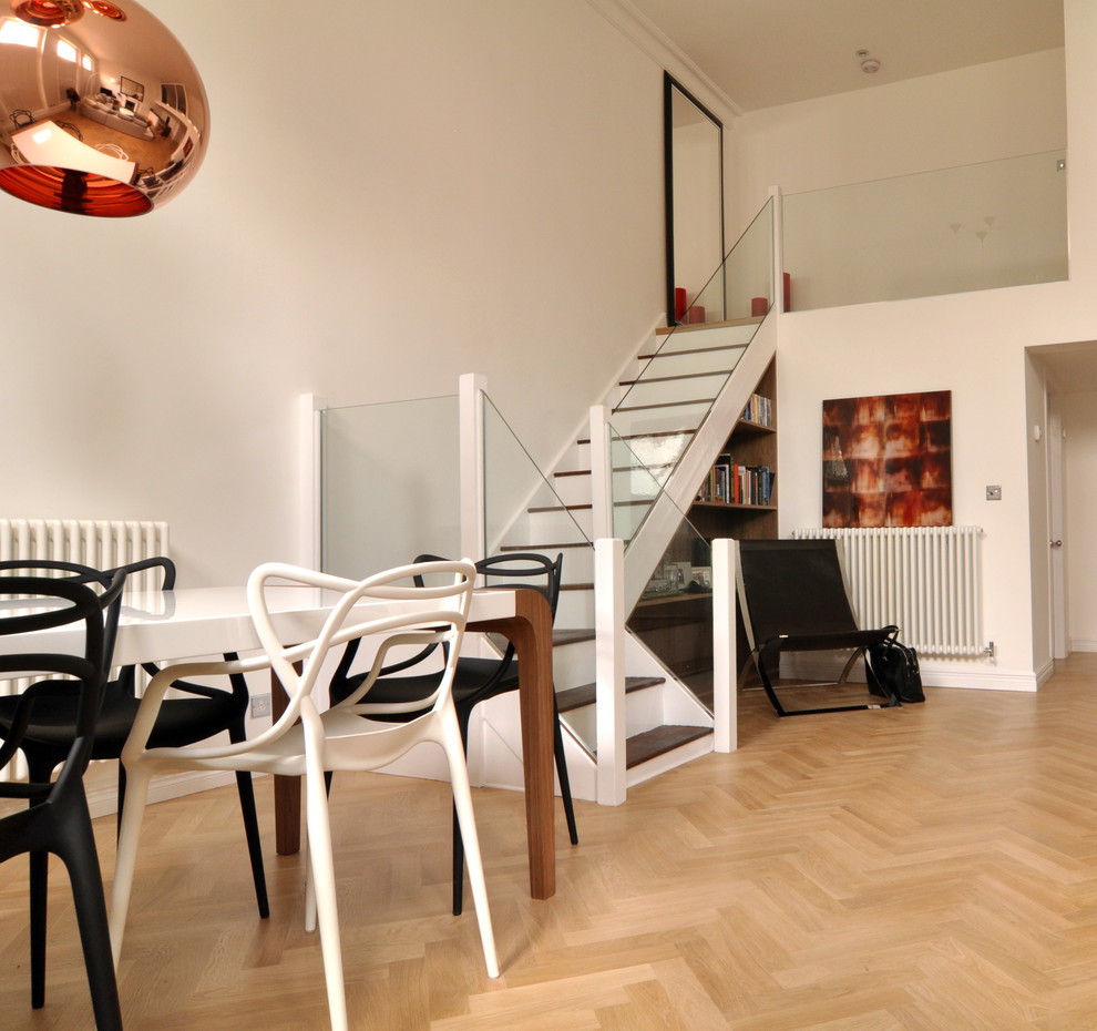 Photo of a contemporary dining room in London with white walls.