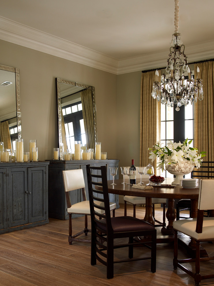 This is an example of a large traditional separate dining room in Houston with beige walls, light hardwood floors and beige floor.