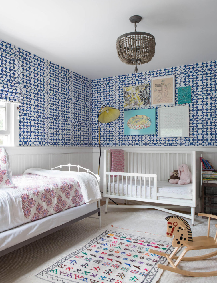 Design ideas for a beach style toddler room for boys in New York with blue walls, decorative wall panelling and wallpaper.