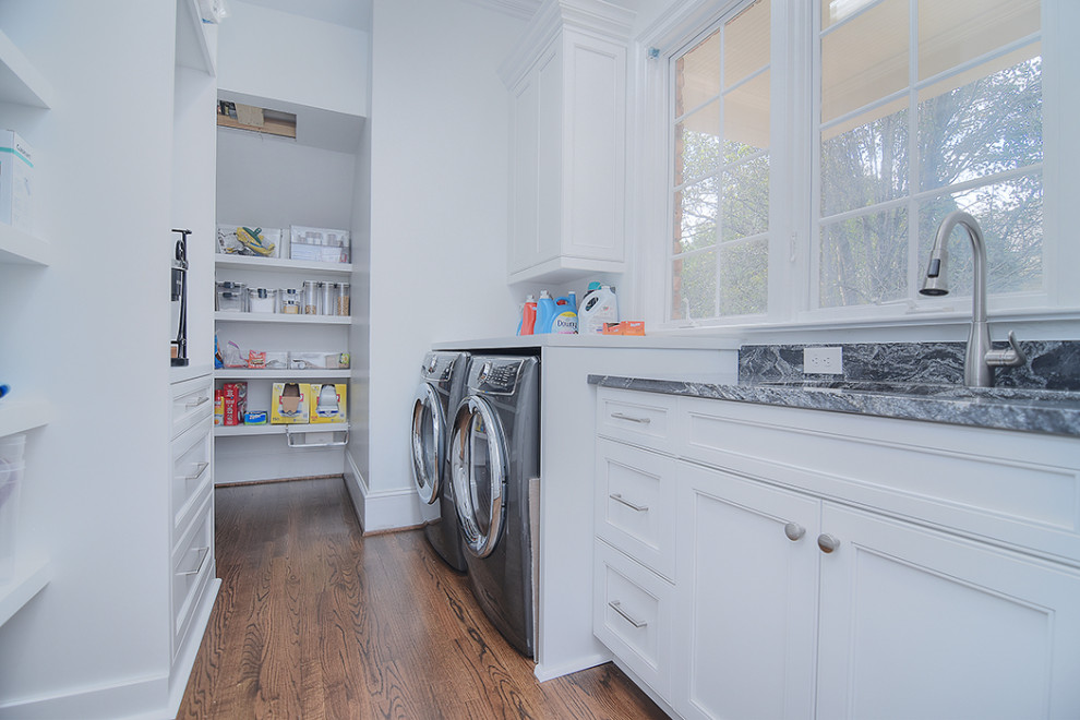 This is an example of a transitional laundry room in Charlotte.
