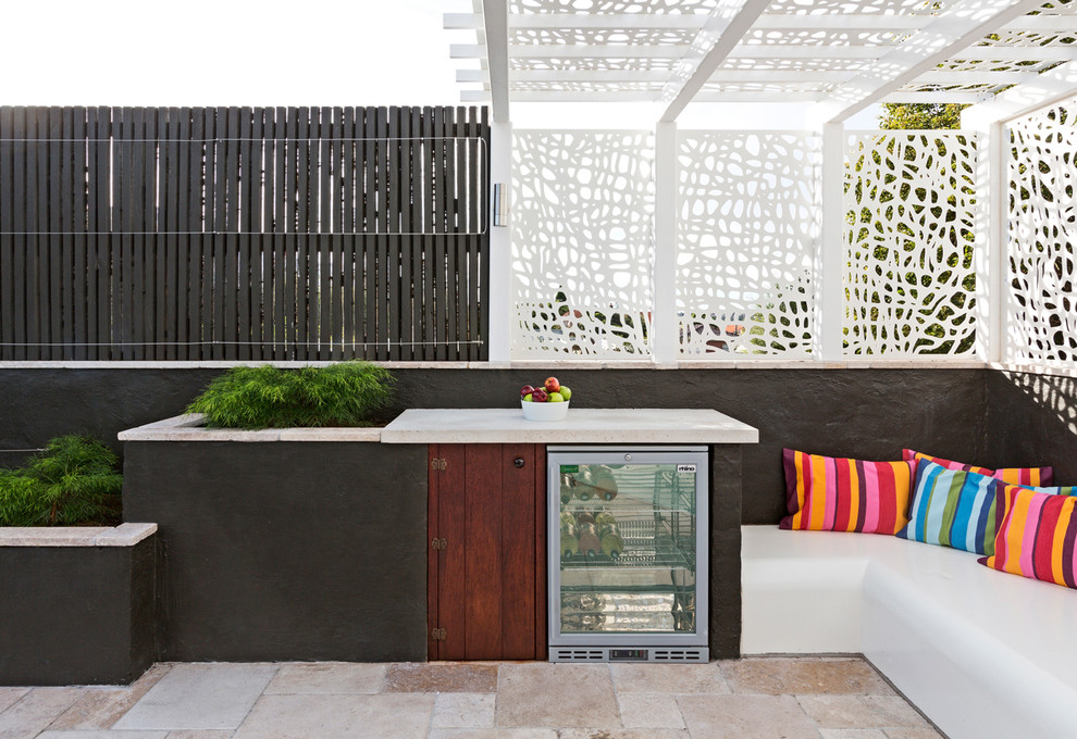 Photo of a mid-sized contemporary backyard garden in Melbourne with natural stone pavers.