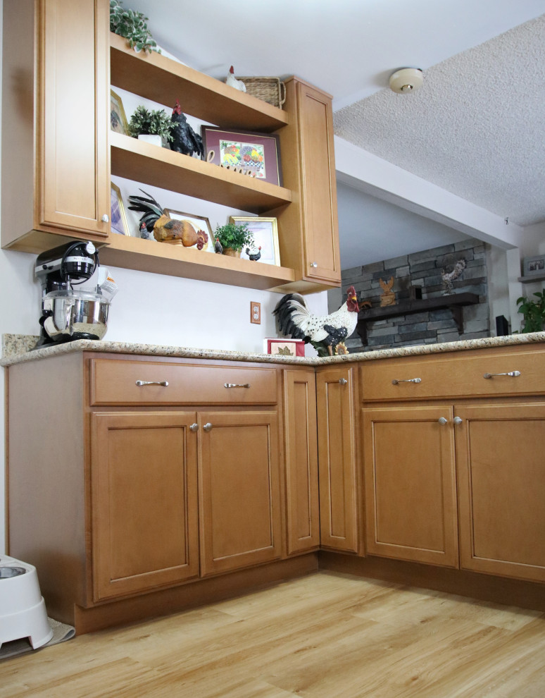 Mid-sized l-shaped kitchen photo with medium tone wood cabinets, granite countertops, no island and multicolored countertops
