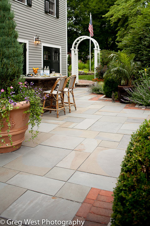 Inspiration for a large transitional backyard patio in Manchester with tile, no cover and an outdoor kitchen.