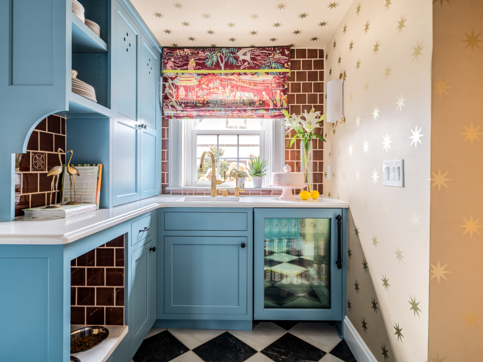 This is an example of a traditional home bar in Cincinnati with blue cabinets, ceramic splashback, ceramic floors, multi-coloured floor, white benchtop and red splashback.